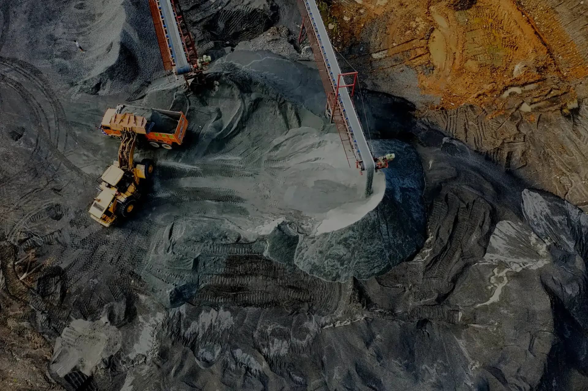Eclipse Miningware backdrop image of a mining operation with a large excavator and dump truck in the foreground, and a mine pit in the background.